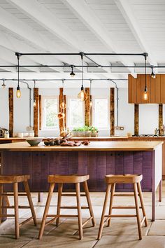 a kitchen with wooden stools and an island