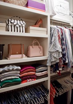 an organized closet with clothes, handbags and purses on shelve shelves