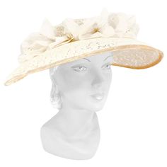 1950s cream-colored starched lace picture hat with handmade french silk flowers, velvet trim, and bow accent. This hat is meant to be worn with a hat pin to secure it to the head. Luxury Vintage Cream Hat, Cream Curved Brim Hat For Church, Adjustable Cream Hat For Evening, Vintage Cream Fascinator For Evening, Vintage Cream Fascinator For Royal Ascot, Cream Vintage Fascinator For Royal Ascot, Vintage Cream Headpiece For Evening, Vintage Cream Mini Hat For Formal Events, Vintage Cream Mini Hat For Formal Occasions