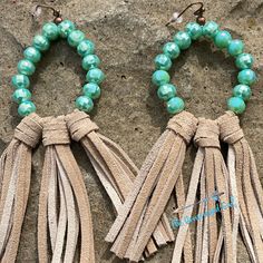 two tasseled bracelets with turquoise beads and leather cords on top of a rock