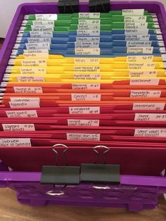 a large purple container filled with lots of folders and binder clippings