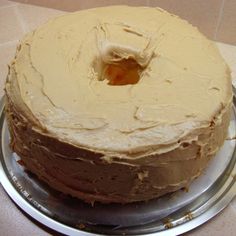 a frosted cake sitting on top of a metal plate