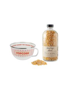 a bottle of popcorn next to a bowl of cereal