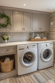 a washer and dryer sitting in a room next to a counter with baskets on it