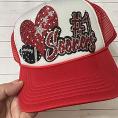 These custom trucker hats are super sparkly and a fun way to promote your favorite team. we can customize the colors, team name, number, and sport to your liking. With so many colors to choose from, the color combinations are endless.  We are happy to answer any questions. The hats are adjustable and fit most sizes.  Trucker style hats are made with a foam front, mesh back, and plastic adjustable closure. Red Letter Print Trucker Hat For Sports Events, Customizable Sports Hat For Fans, Customizable Sports Fan Hats For Fan Gear, Personalized White Trucker Hat For Sports Events, Customizable Sports Fan Hat For Baseball Season, Customizable Baseball Sports Fan Hat, Personalized Trucker Hat For Sports Events, Game Day Team-colored Trucker Hat With Letter Print, Team-colored Trucker Hat With Letter Print For Game Day