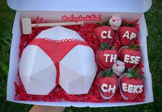 there is a cake in the box with strawberries on it that says clap them