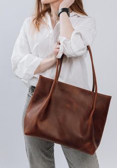 ● Bag with inner pockets and stitched handles of perfect shape. Sewn from thick leather and keeps its shape well. You can use it for shopping, laptop, phone, etc. Bag has a zipper so your items will be safe. It can be a wonderful gift for your loved ones and family ● ●There are manufacturing options for the bag in 11 colors: cognac, chocolate, black, caramel, olive, yellow, burgundy, green, blue, cappuccino, navy blue and red ● ● We can place your initials on the bag using laser engraving, embossed with gold or silver foil. But first you need to contact us and clarify the details ● ● We guarantee high quality handmade ● ● DIMENSIONS ● Height: 12 inches (30 cm) Width: 14.5 inches (37 cm) Depth: 6.5 inches (16 cm) 2 inside pockets Large pocket Height: 7 inches (18 cm) Width: 10.5 inches (27c Brown Satchel With Rolled Handles For Errands, Brown Shoulder Bag With Rolled Handles For Shopping, Classic Shoulder Bag With Rolled Handles For Errands, Brown Bag With Long Handle For Everyday, Everyday Brown Shoulder Bag With Long Handle, Leather Bags With Rolled Handles For Errands, Leather Shoulder Bag With Rolled Handles, Leather Shoulder Bag With Rolled Handles For Errands, Brown Leather Hobo Bag With Rolled Handles