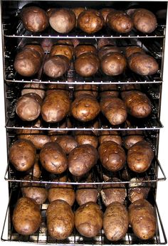 there are many baked items in the oven on this rack, including potatoes and mushrooms