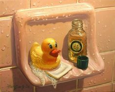 a yellow rubber ducky sitting on top of a bathroom shelf next to a bottle