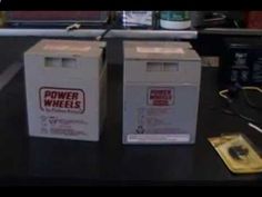 two boxes sitting on top of a table next to each other with power wheels written on them