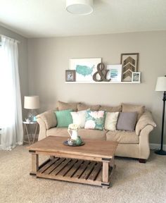 a living room with furniture and pictures on the wall above it that says, our front room makeover a long overdue reveal