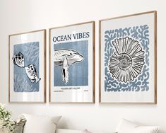 three framed posters on the wall above a couch