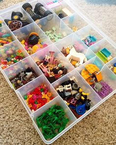 a plastic container filled with lots of different types of legos and building blocks on the floor