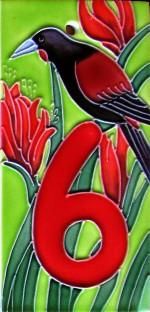 a bird sitting on top of a number six tile wall art piece in red and green