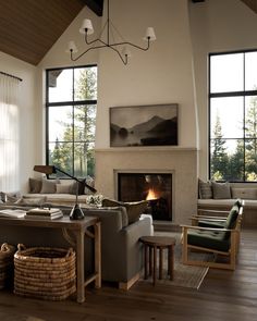 a living room filled with furniture and a fire place in the middle of a room