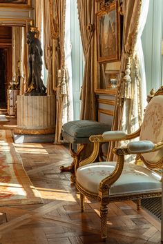 an ornately decorated living room with gold trimmings and paintings on the walls