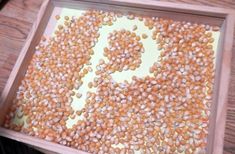 a tray filled with corn on top of a wooden table