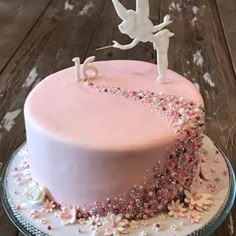 a cake decorated with pink frosting and decorations