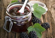 blackberry jam with fresh blackberries on wooden table