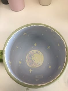 a bowl with stars and the moon painted on it