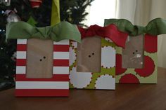 three small bags with faces are sitting on a table next to a christmas tree,