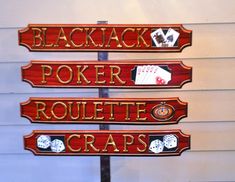 three wooden signs that say blackjack, poker, rouleette and craps