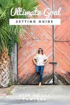 a woman standing in front of a wooden door with the words ultimate goal setting guide