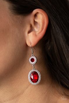 Encrusted in rings of glittery white rhinestones, two fiery red gems connect into a glamorous lure as they elegantly trickle from the ear. Earring attaches to a standard fishhook fitting. Sold as one pair of earrings. P5RE-RDXX-102XX Oval Crystal Jewelry With Rhinestones, Oval Rhinestone Jewelry Gift, Oval Shaped Rhinestone Jewelry For Gifts, Red Crystal Drop Earrings, Red Crystal Jewelry With Matching Earrings, Red Crystal Dangle Jewelry, Red Jeweled Metal Earrings, Oval Crystal Earrings For Party, Glamorous Red Jewelry With Sparkling Stones