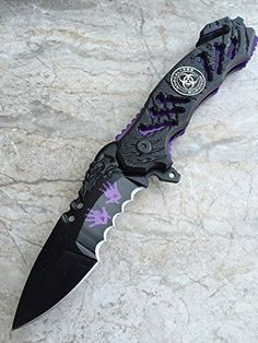 a black and purple knife on top of a marble counter with the blade cut out