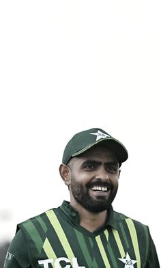 a man with a beard wearing a green and white uniform