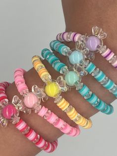 the bracelets are all different colors and have charms on them, as well as beads