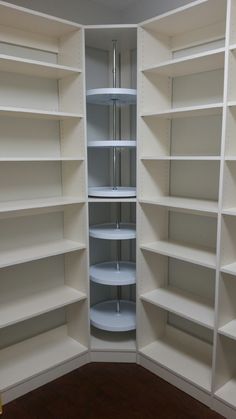 an empty white closet with shelves in it