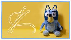 a crocheted blue and yellow stuffed animal next to scissors