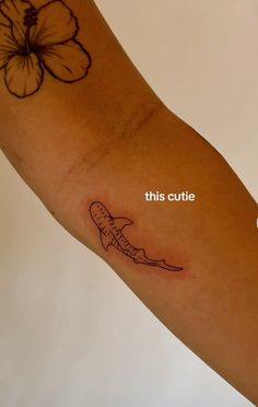 a small tattoo on the arm of a person with a flower in it's center