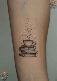 a coffee cup on top of books tattoo