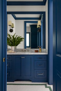 a bathroom with blue cabinets and white tile flooring