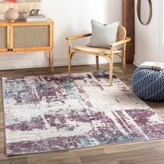 a living room with a chair and rug on the floor