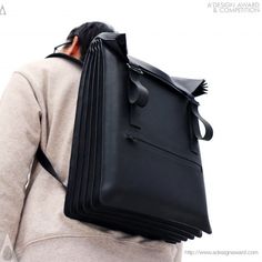 the back of a person carrying a black bag