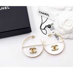 Chanel Brand New Gold CC Transparent Large Hoop Earrings * Marked 23 * Made in Italy *Comes with the original dustbag, pouch, tag, booklet, ribbon and tag – It is approximately 2″ x 2″. – Brand New 13298-1243  Please see the measurements section for best approximate dimensions. White Luxury Hoop Earrings, Luxury White Round Hoop Earrings, White Hoop Earrings For Evening, Luxury White Hoop Earrings For Evening, Designer White Earrings For Party, Designer White Earrings For Evening, Chanel Brand, Large Hoop Earrings, Vintage Cartier Bracelet