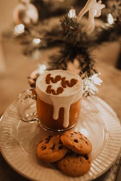 a cup of hot chocolate and cookies on a plate