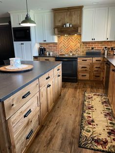 a kitchen with wooden cabinets and an area rug on the floor in front of it