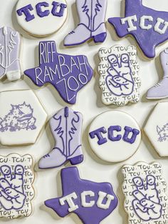 decorated cookies are arranged in the shape of texas, tcu, and texas boots