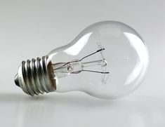 an electric light bulb on a white surface with no lighting bulbs in the middle and two wires running through it