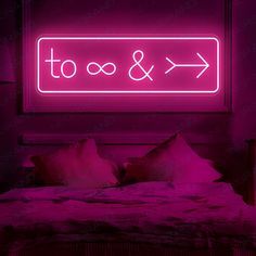 a bed in a room with a neon sign above it that says & xo to