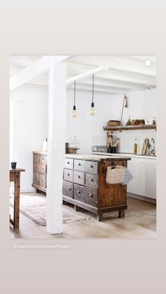 an open kitchen with white walls and wooden floors