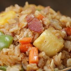 a bowl filled with rice and vegetables on top of a table