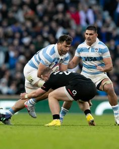 two men are playing rugby on the field