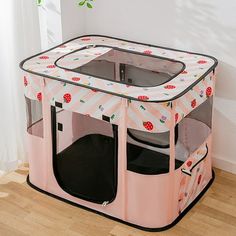 a pink playpen with ladybugs on it and the door open to allow children to sit inside