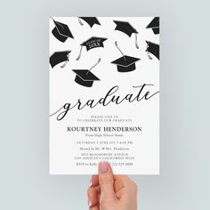 a hand holding up a card with graduation caps on it and the words graduate written in black ink