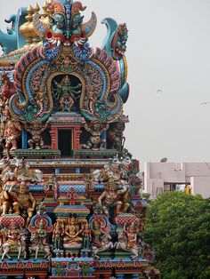 an elaborately decorated tower with statues on top